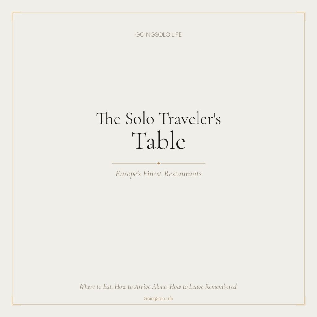The Solo Traveler's Table dining guide on a table at a Parisian cafe.